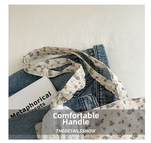 Close-up of floral tote bag featuring white lace edges and a comfortable carry handle