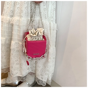 Detail of fuchsia box bag with chunky silver chain and white drawstring liner