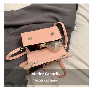 Internal capacity detail of pink bow crossbody bag showing space for small perfume bottles