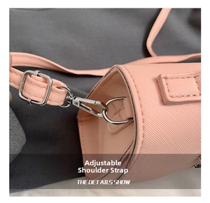 Detail showing adjustable strap with silver swivel clasp on pink Saffiano leather bag