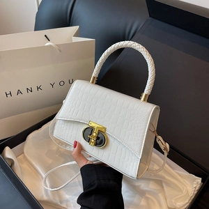White crocodile embossed leather handbag with woven handle and gold T-lock in gift packaging