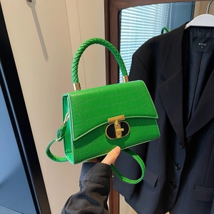Chic green crocodile embossed handbag with woven handle and gold T-clasp buckle