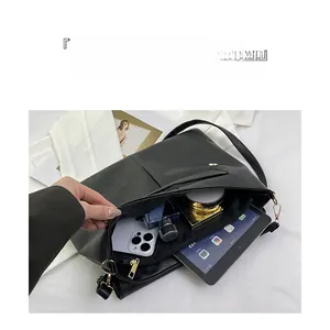 Detail of black pebbled leather tote with internal compartments for tablet and essentials