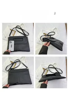 Detail views of black leather tote bag with chain strap and lychee grain texture