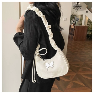 Detail of white butterfly shoulder bag with scrunchie strap and pleated texture