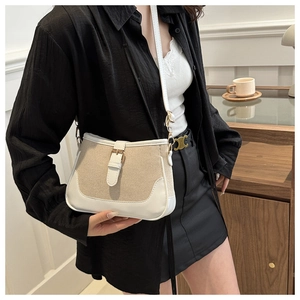 Chic beige canvas and white leather handbag shown styled as a casual crossbody bag