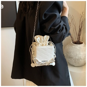 White mini drawstring bucket bag with chain strap and stylish rich rabbit logo print