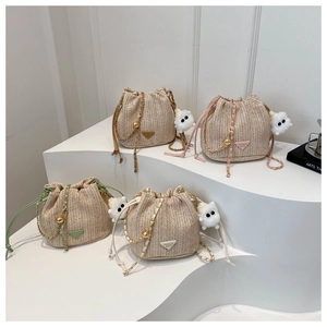 Collection of straw bucket bags with chain straps and plush cat charms in four colors