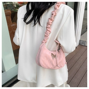 Pink pleated shoulder bag featuring a silver butterfly hardware and ruched handle detail