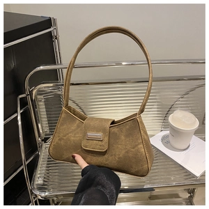 Close-up of retro minimalist dark brown baguette bag with silver metal buckle on display