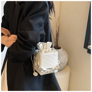 Detail of white leather box bag with rich rabbit embossing and silver chain handle