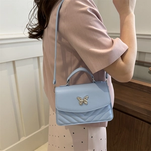 Light blue minimalist PU leather crossbody bag with silver butterfly clasp and V-quilt pattern