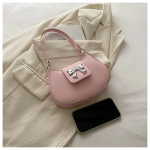 Close-up of pink hobo bag with a silver metallic bow and smooth matte PU leather finish