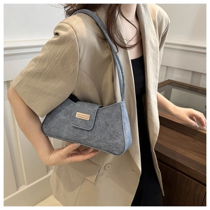 Gray vintage underarm bag worn with a khaki blazer showing fit and long shoulder strap