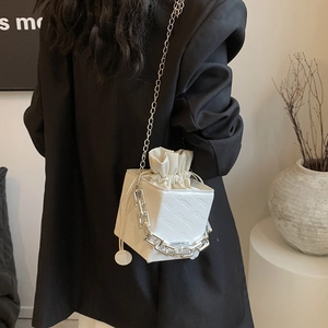 Minimalist white box shoulder bag with drawstring and silver chain on model back view