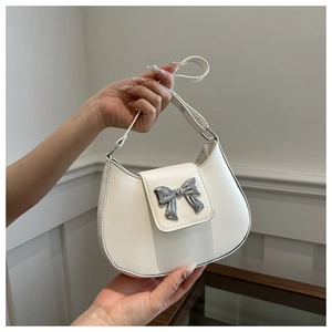 Mini white leather underarm bag with a silver metallic bow decoration and short handle