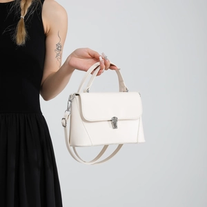 Chic beige textured leather crossbody bag with silver buckle clasp and top handle