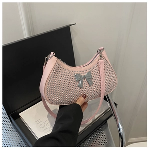 Close-up of pink half-moon underarm bag with silver studs and metal bow buckle detail