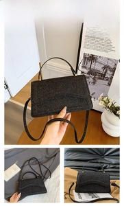 Detail of black glitter crossbody bag with top handle and shimmering silver texture