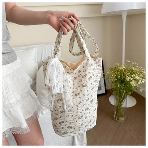 Macro detail of floral canvas tote bag with elegant white lace decorative bow