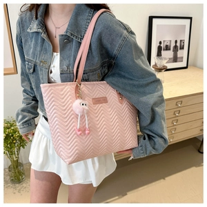 Pink quilted leather tote bag with fluffy monster charm and fashion label detail