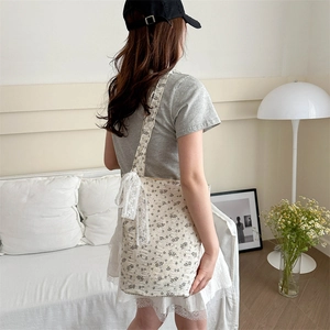 Floral canvas tote bag with lace bow details on shoulder, elegant vintage bucket style