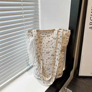 Quilted floral tote bag with lace detail on white windowsill under soft natural light