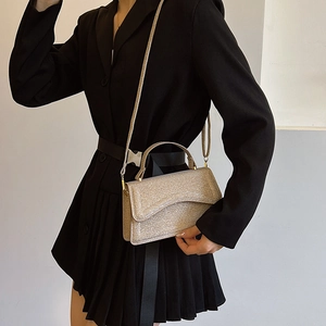 Elegant gold glitter handbag for women with a shoulder strap and handle in a 2024 trendy design