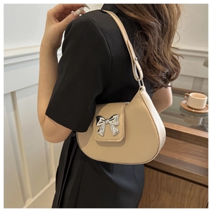 Beige crescent hobo bag for women with silver bow buckle and slim shoulder strap