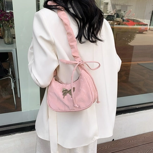 Pink crescent underarm bag with metal butterfly and stylish ruffled bow shoulder strap