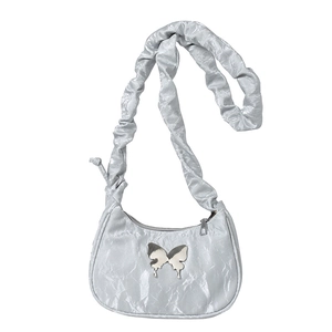 Silver crescent shoulder bag with metallic ruched fabric and butterfly hardware detail