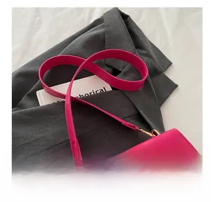 Detail view of the magenta leather strap with elegant gold metal hook attachments