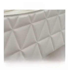 Close-up of white leather texture with geometric triangular quilting detail