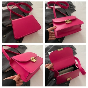 Detailed close-up of pink leather crossbody bag showing metal buckle and interior capacity