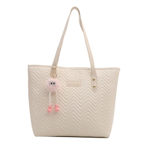 Quilted beige tote bag with chevron pattern, top handle and pink plush monster charm