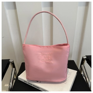 Detailed view of pale pink nylon tote featuring onwards and upwards 3D embroidery