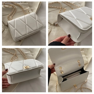 Detail view of white quilted chain bag showing interior capacity and golden metal lock