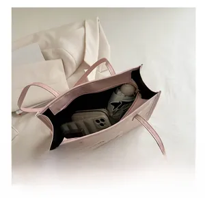 Interior view showing the large capacity of the pink tote bag with daily essentials