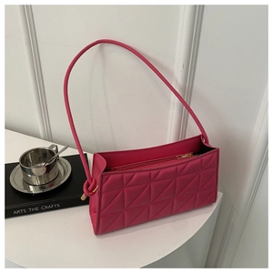 Detail of rose pink quilted crossbody bag with geometric stitching and silver zip closure
