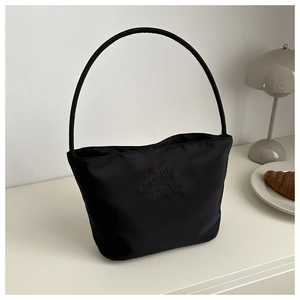 Minimalist black nylon tote bag with long slim handles and onwards and upwards text
