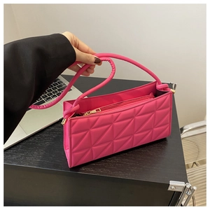 Detail of rose pink rectangular bag with geometric triangle quilting and gold zipper