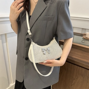 Sparkling white rhinestone crescent underarm bag with silver bow accent and slim strap