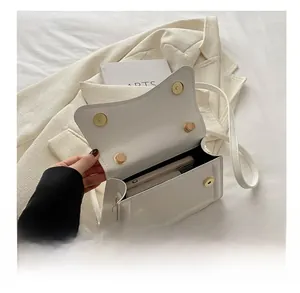 Interior view of white crossbody bag showing ample space for phone and wallet essentials