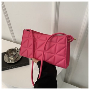 Detail of rose pink quilted PU leather shoulder bag with elegant diamond stitching texture