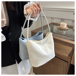 Detailed close-up of nylon tote bags with onwards and upwards letter embroidery
