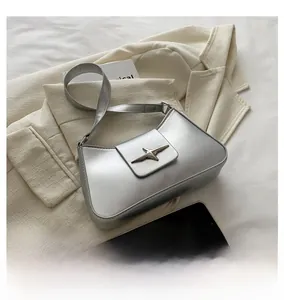 Detail view of silver hobo shoulder bag with metallic star buckle and adjustable strap