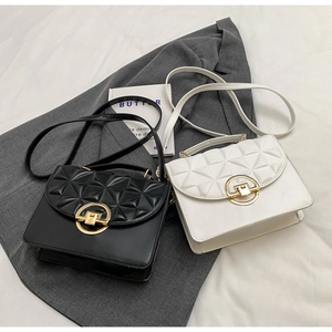 Detail of square crossbody bags featuring geometric quilted patterns and gold twist locks