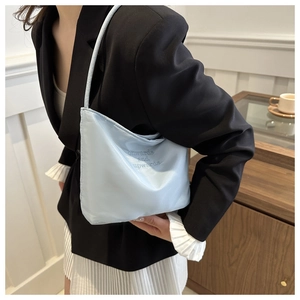 Detail of light blue cloud-shaped shoulder bag with onwards and upwards embroidery