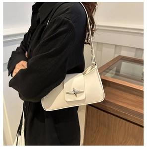 Detailed side view of white leather shoulder bag with a silver star buckle ornament