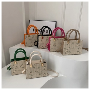 Close-up of six-color woven crossbody bags featuring floral embroidery and rope handles